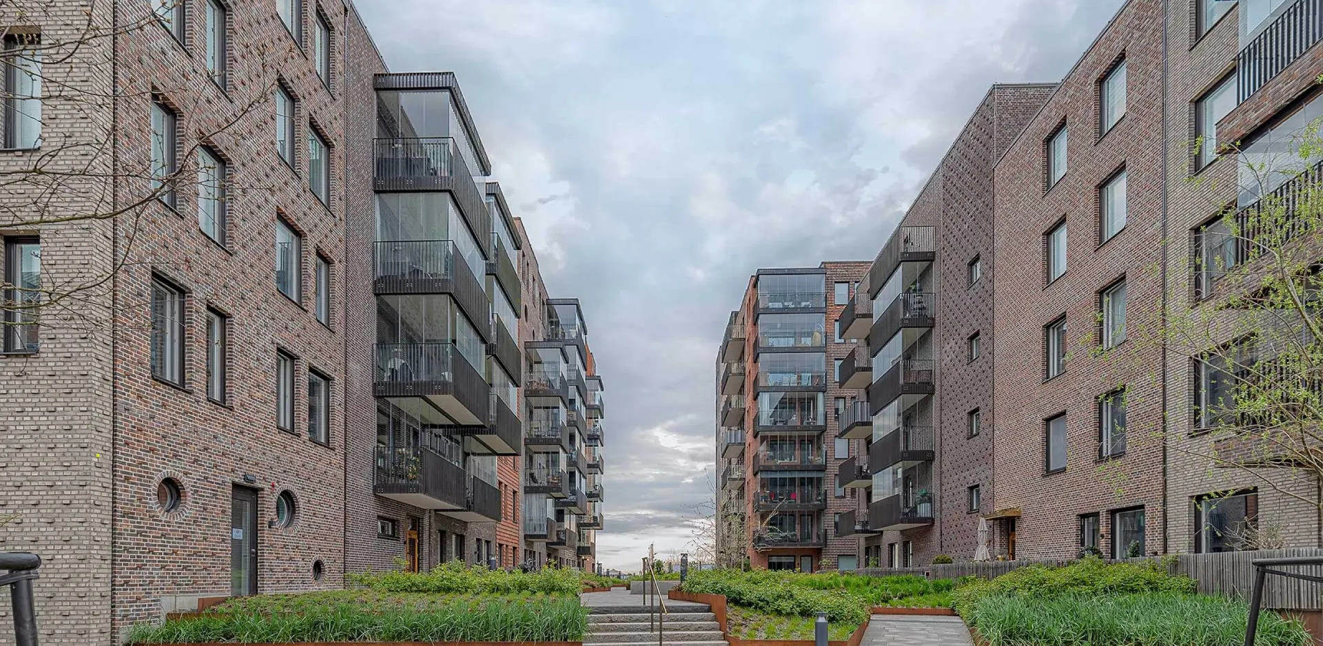 Brick apartment buildings with modern balconies.