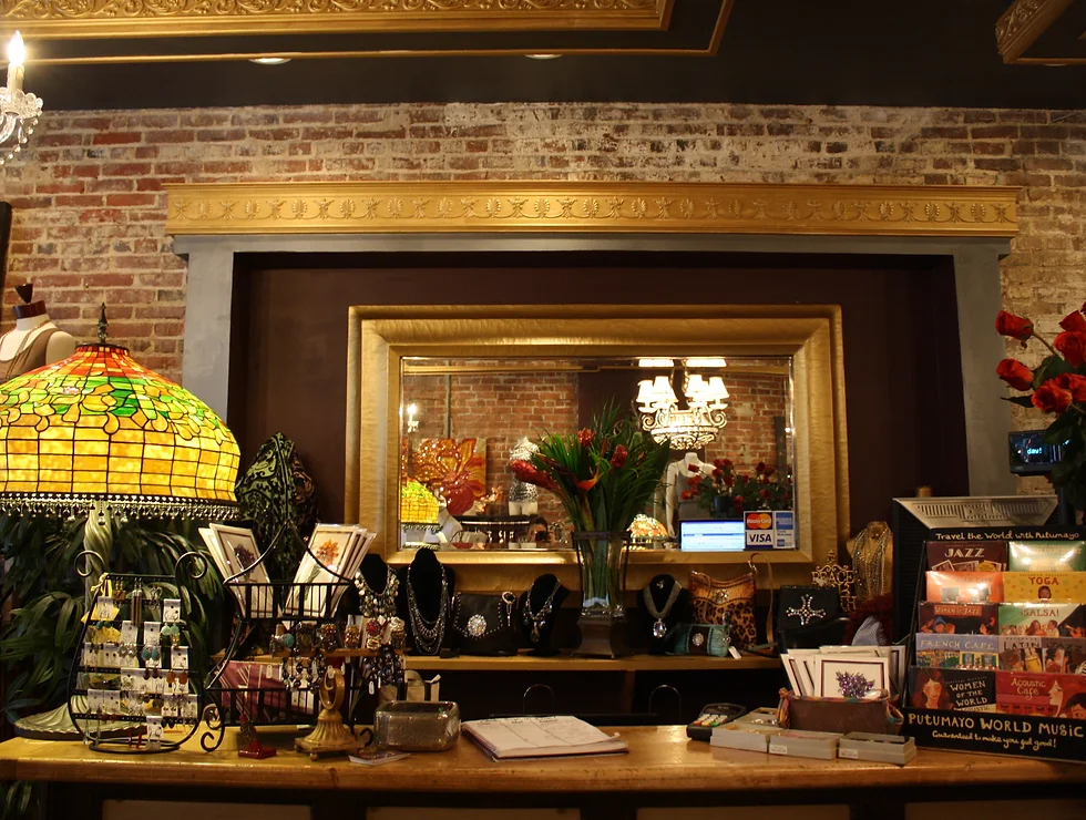 Boutique shop counter with jewelry and lamp.