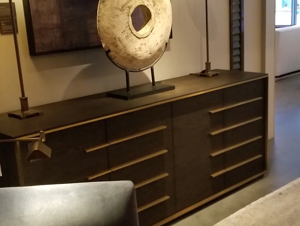 Dark wood sideboard with brass pulls.