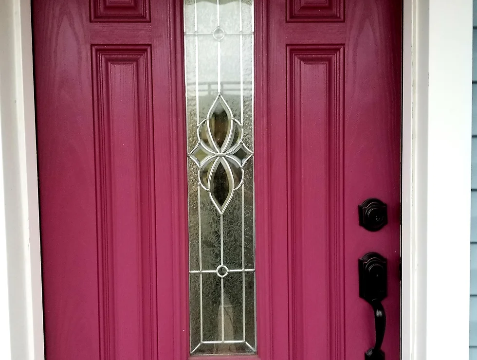 Burgundy door with glass insert and black handles.