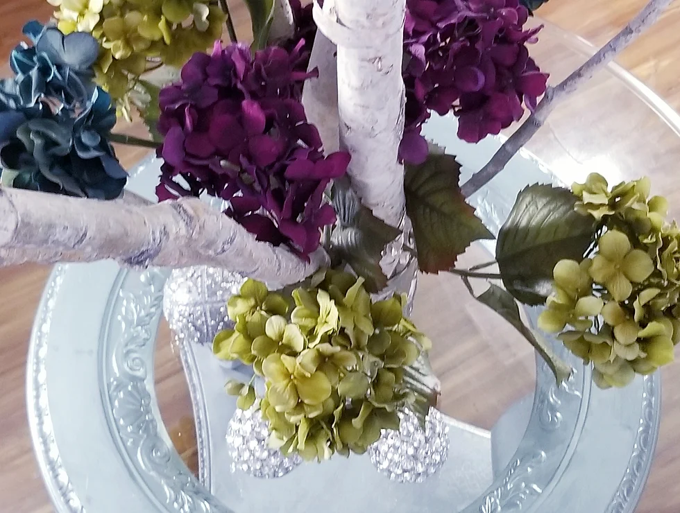 Colorful hydrangeas in a glass vase.